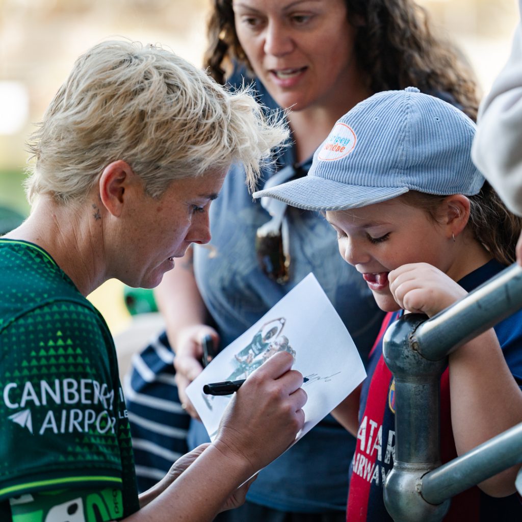 Michelle Heyman signs for a fan.